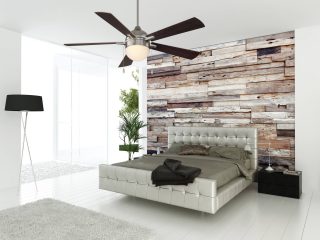 A sleek, contemporary bedroom complete with different textiles and a modern ceiling fan